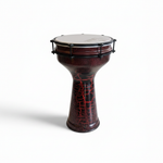 Unbranded Syrian Mukasir Star darbuka standing upright at a 45 degree angle, showing the star-patterned body, drumhead, rim, base, and hardware on a clean white background