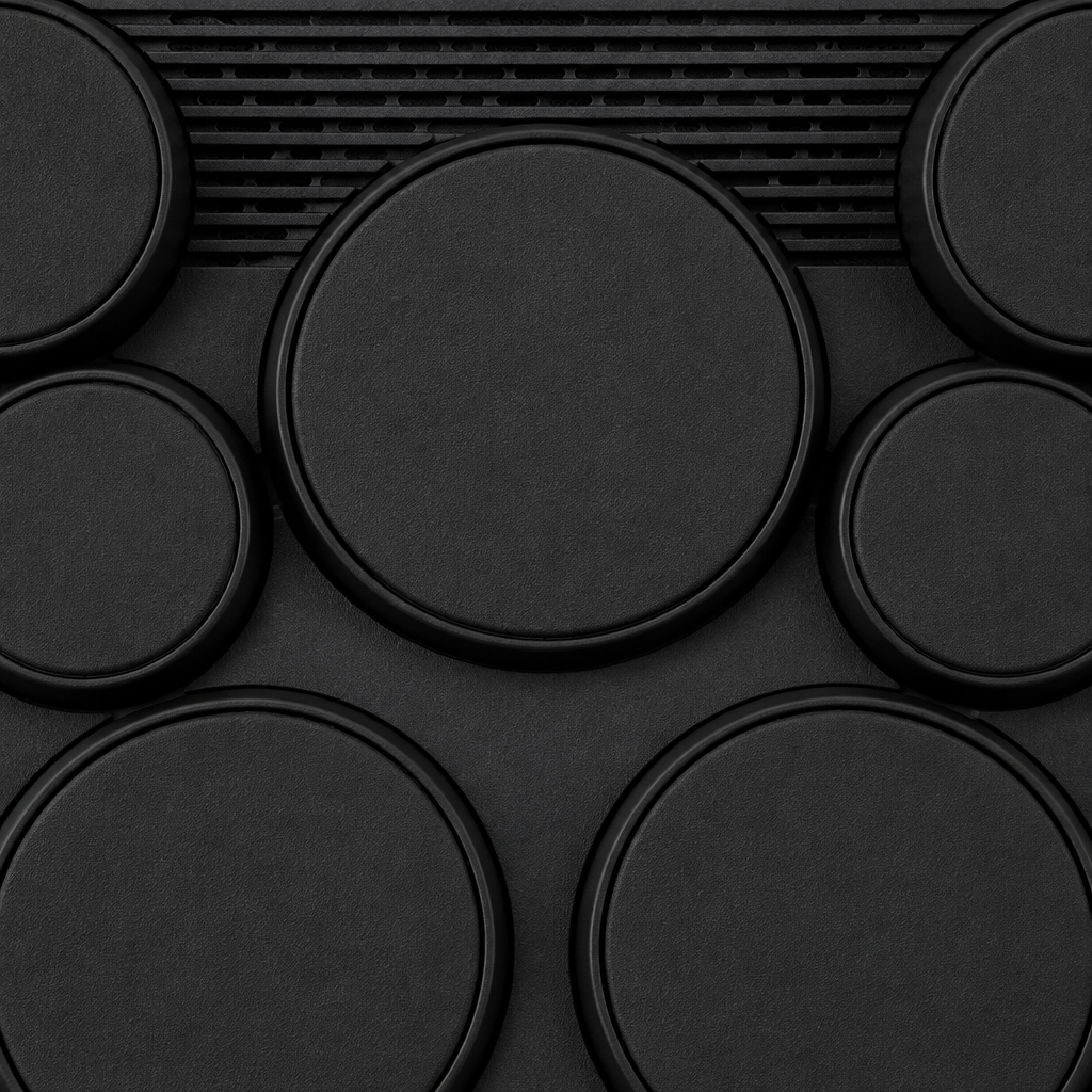 Close-up detail of the Yamaha DD-75's black drum-pad surfaces and raised rims.