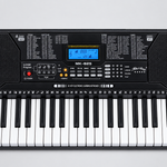 Close detail of the unbranded MK825 electronic learning keyboard LCD screen, control panel, speakers, buttons, and upper keys