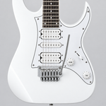 Close-up of the Ibanez GRG140-WH white electric guitar pickups, bridge, strings, and controls against a light gray background.