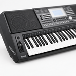 Close-up of the Medeli A810 keys and speaker grille with the control panel softly out of focus.