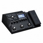 Close three-quarter view of the Zoom G2X Four guitar multi-effects processor showing the display, control knobs, footswitches, and expression pedal