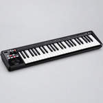 Three-quarter view of the black Roland A-49 BK MIDI controller showing its keys and left-side controls.