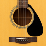 Close-up of the Yamaha F310's soundhole, rosette, strings and spruce top.
