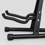 Close detail of the unbranded J-40E guitar stand padded contact arms, folding joint, frame, and rubber foot