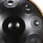 Close-up of raised tone fields on the black steel handpan surface