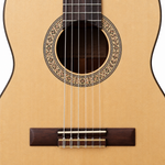 Close-up of the Yamaha C40MII's soundhole, rosette, strings and natural spruce top.