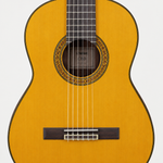 Straight-on close-up of the Yamaha C80 classical guitar soundhole, rosette, strings, and bridge.