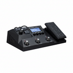 Zoom G2X Four guitar multi-effects processor shown in a complete three-quarter view with display, footswitches, expression pedal, and side connections