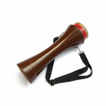 Kasoor traditional hand drum lying down at an angle with its shaped brown body, red-accented top rim, and black shoulder strap visible on a white background