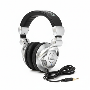 Behringer HPX2000 closed-back DJ headphones shown in a complete three-quarter view with swiveling ear cups and cable on a white background