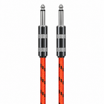Straight close-up of the Luxars LCB-6A red patterned instrument cable showing its two matching plugs, housings, strain reliefs, and cable jacket