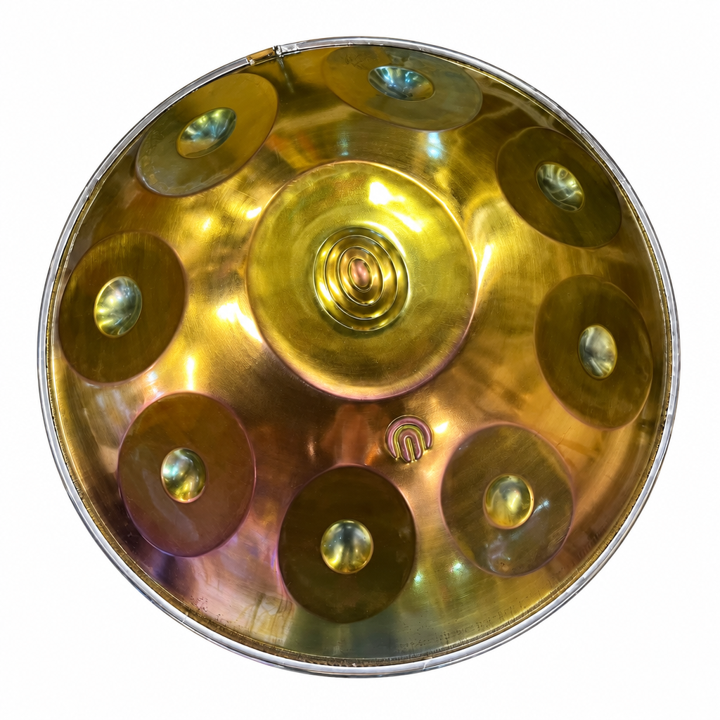 Egyptian-inspired metal handpan drum, straight top view showing the central dome and raised tone fields