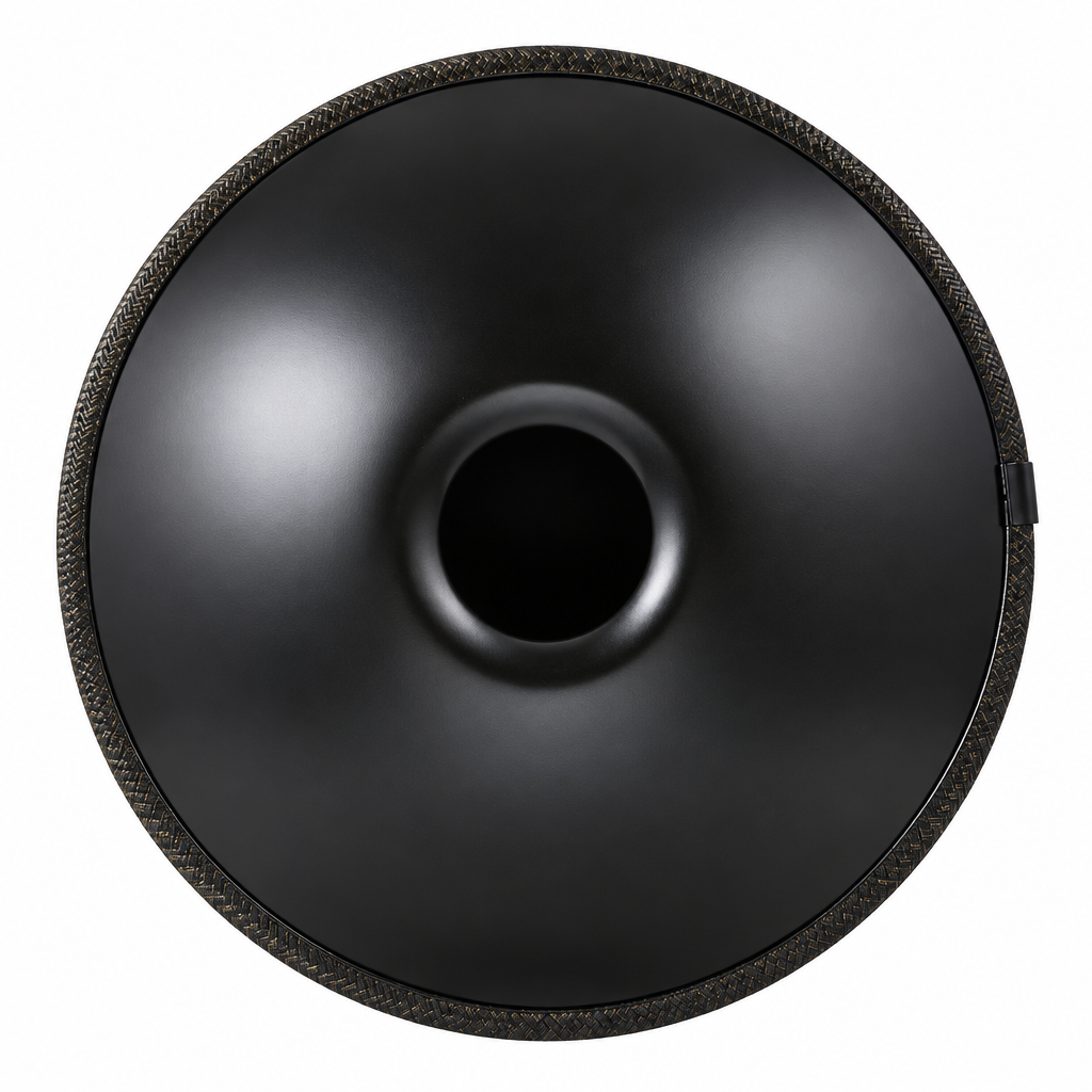 Underside of a black steel handpan showing the center sound opening and braided edge