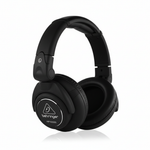 Behringer HPX6000 black professional DJ headphones shown at an angle with Behringer branding, over-ear cushions, and rotating earcup construction