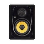 Black studio monitor speaker with yellow center on a white background